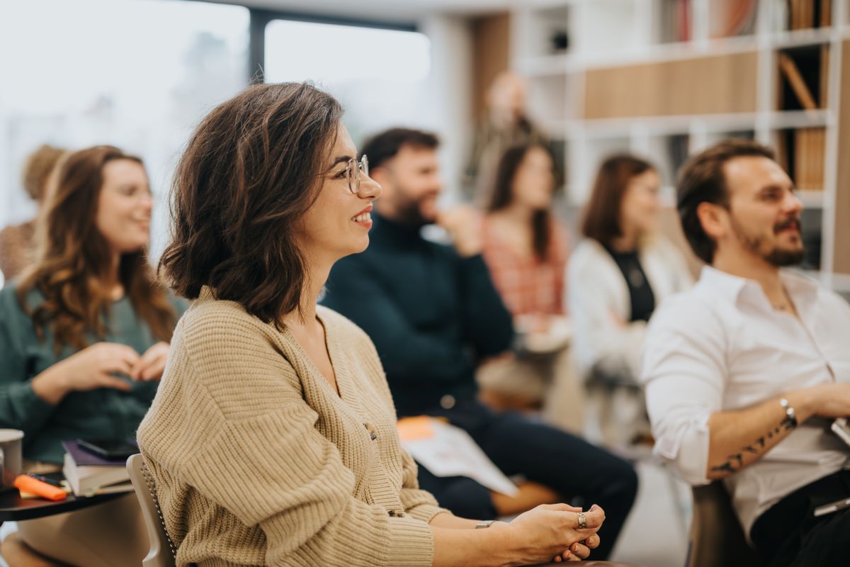 Office workers listen to a presentation