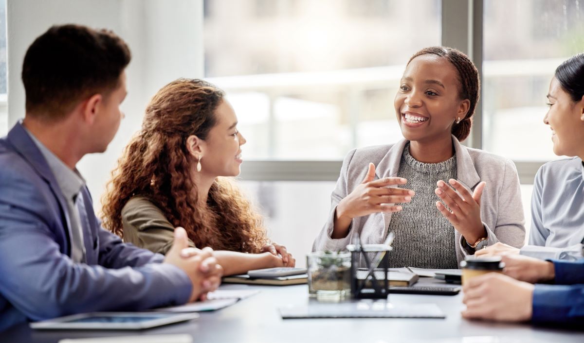 A woman speaks to her coworkers