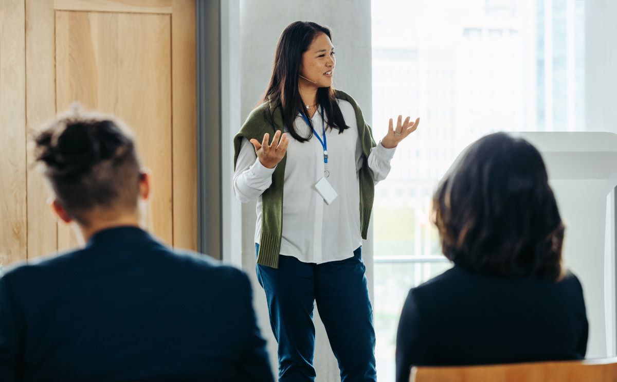 A woman speaks in a corporate environment