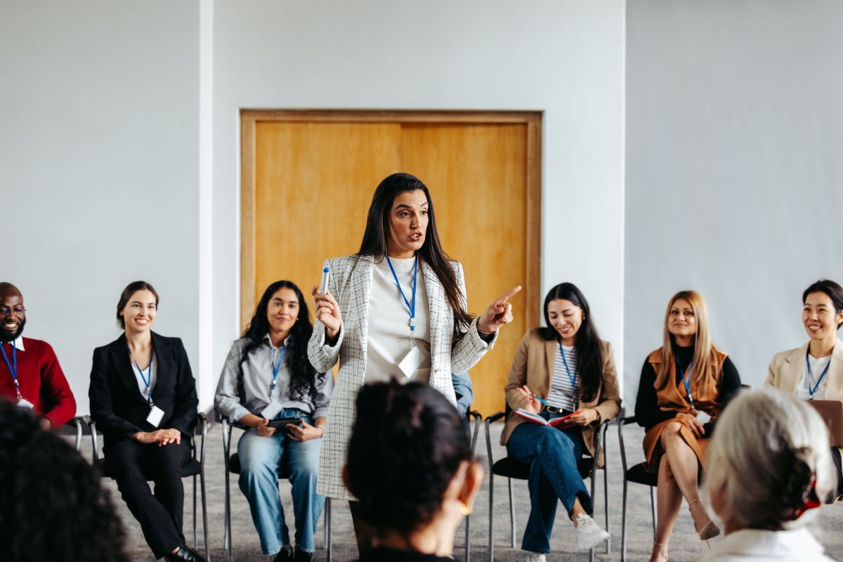 A woman presents to a room of employees