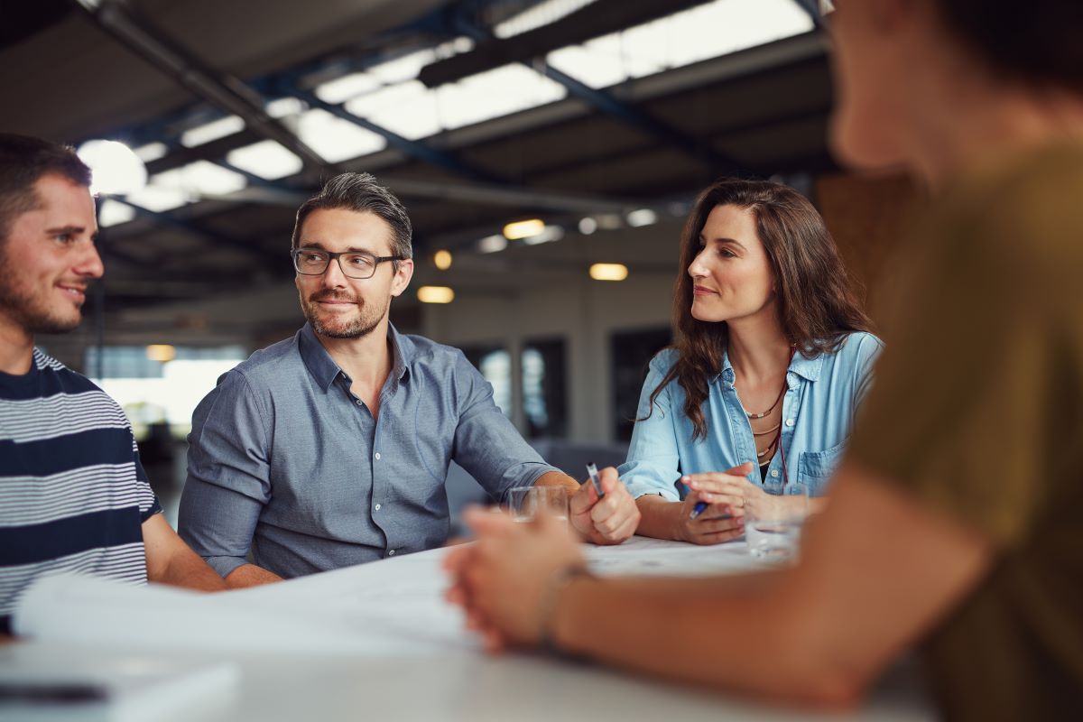 Work colleagues meet around a table.