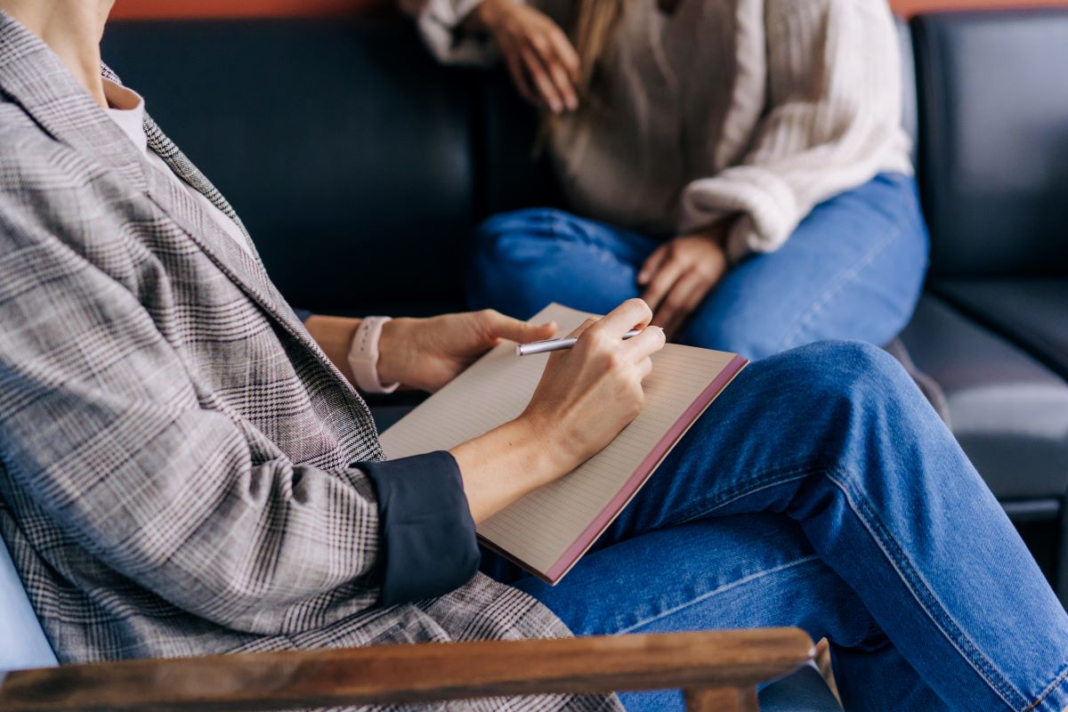 A counsellor takes notes.