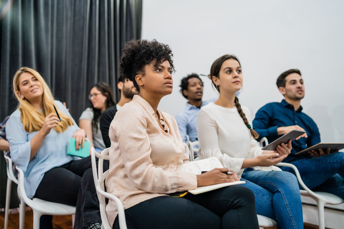 A group of coworkers listen at a meeting