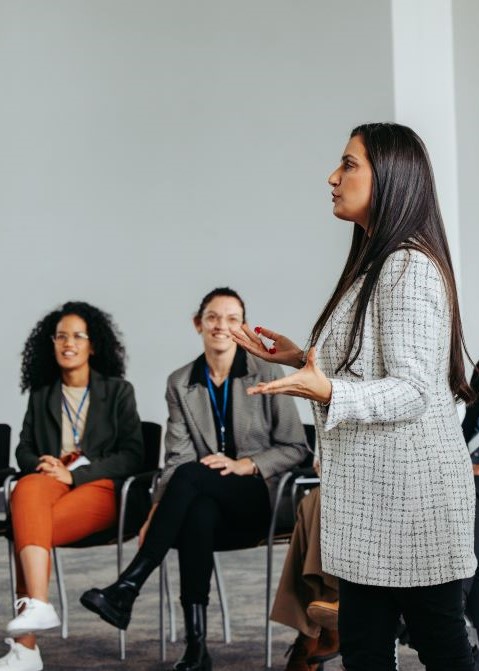 A woman presents in an office setting.
